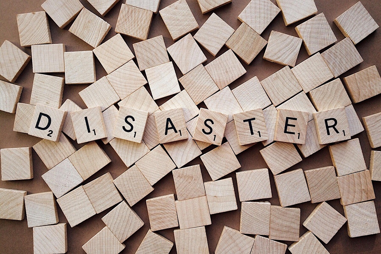 disaster spelled out with scrabble tiles